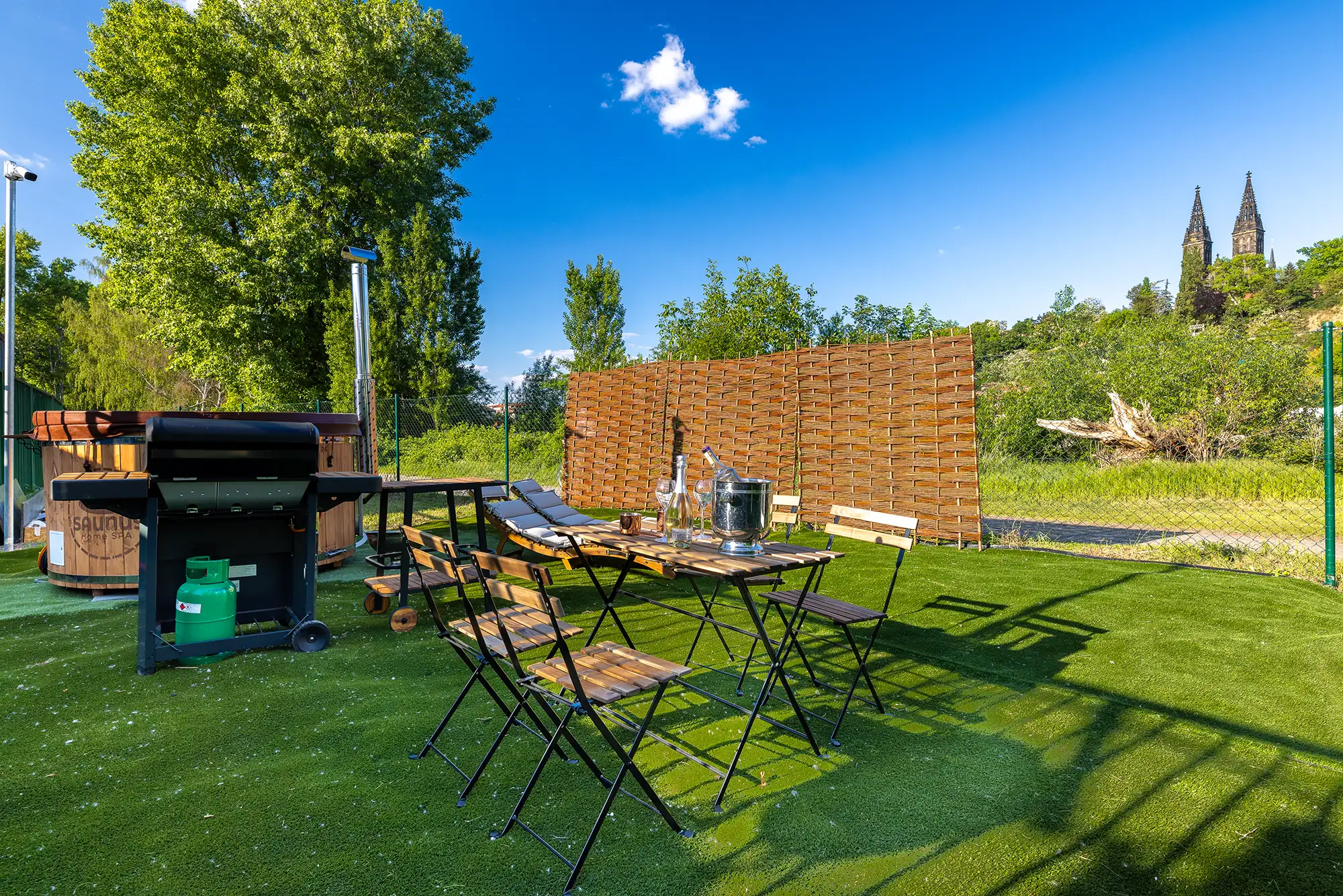 Wood-fired hot tub and outdoor dining table on the dome's private deck